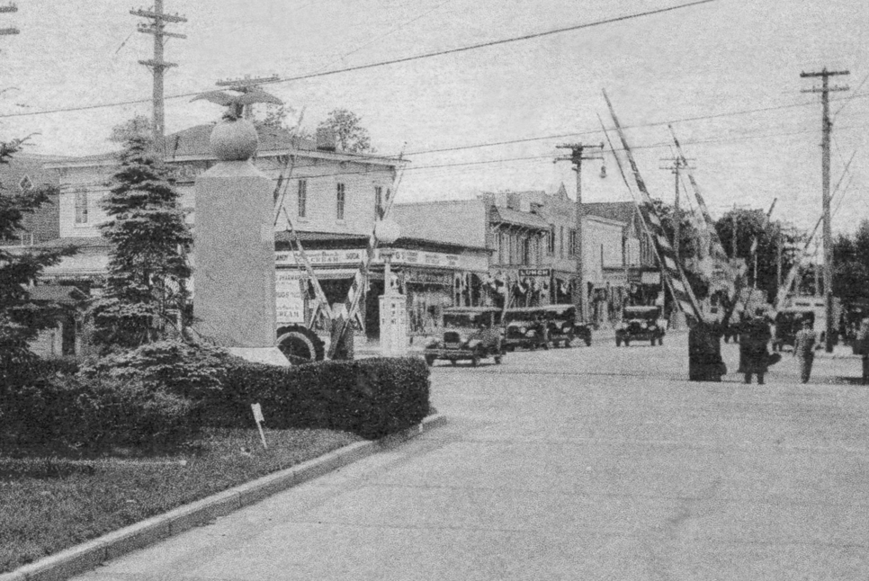 Black and white photo of railroad crossing. 