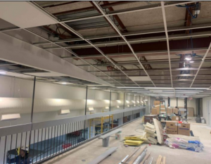 Photo of interior of building with open ceiling. 