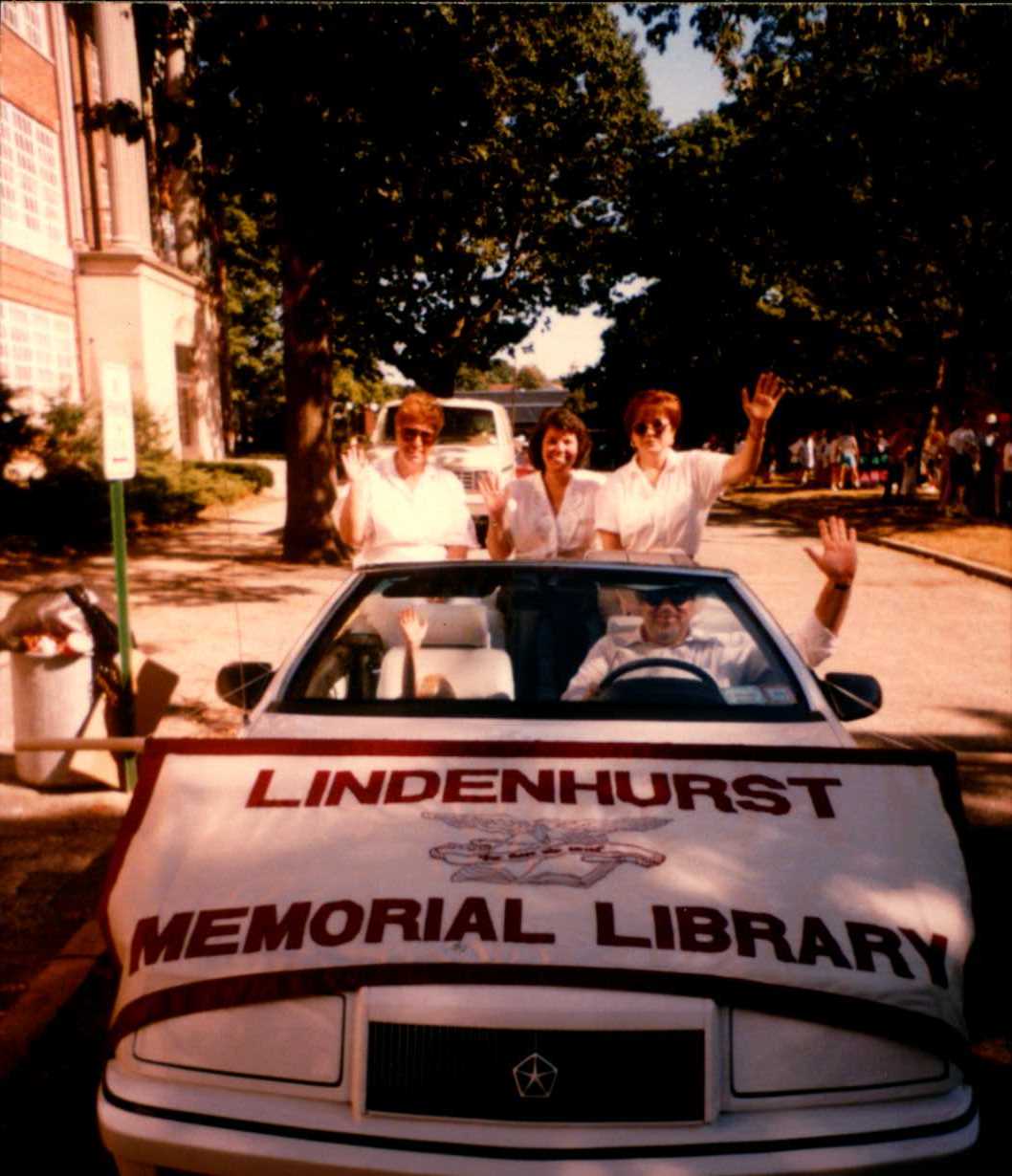 Lindenhurst Memorial Library on parade in a white convertable. 