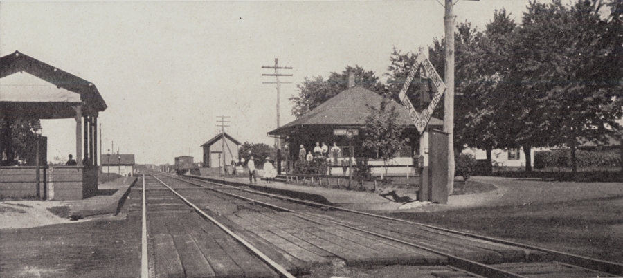Black and white photo of the railroad station. 