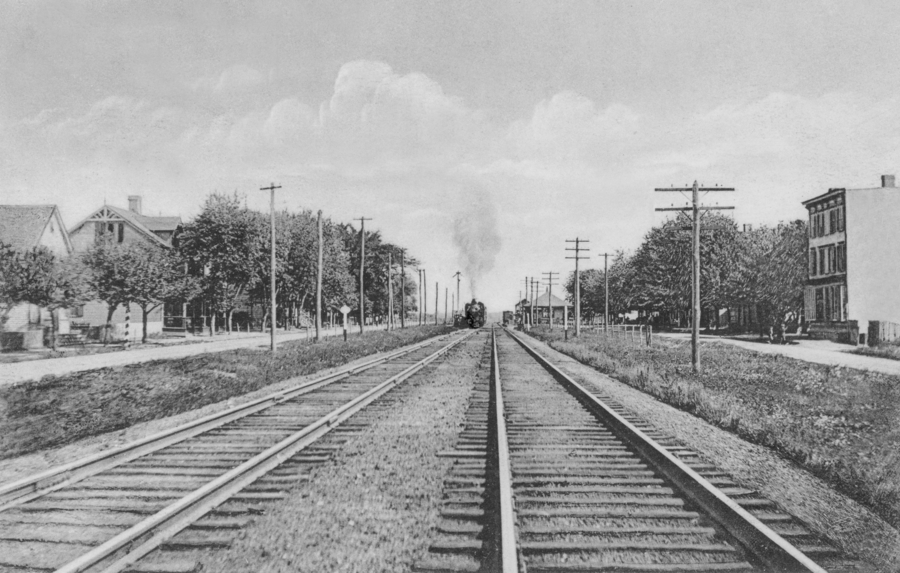 Black and white photo of railroad tracks. 