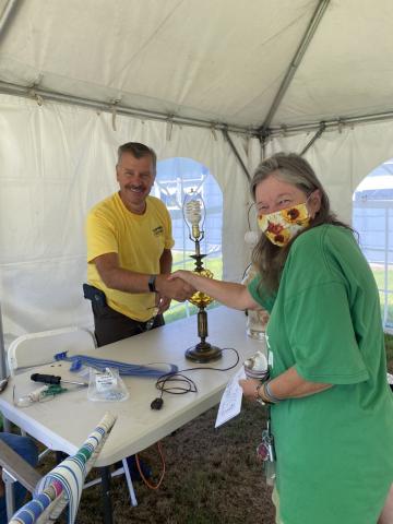 Patron is having her lamp fixed. 